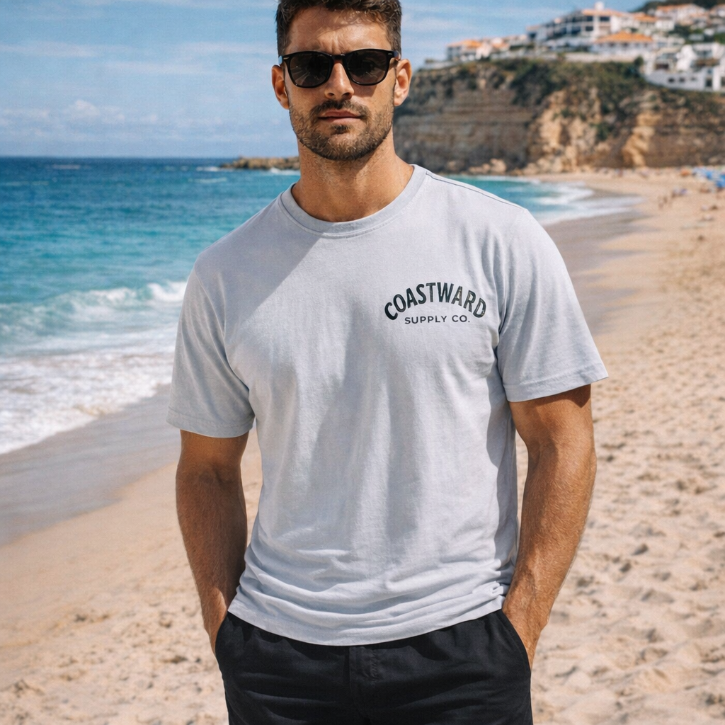Adult in grey shirt. Wordmark logo. Near beach. 